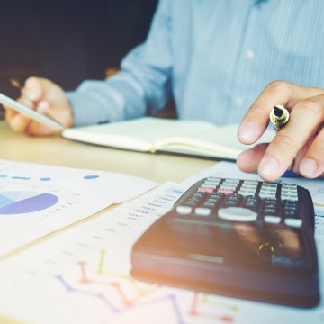 man on calculator papers accounting software